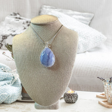 Blue Lace Agate crystal pendant necklace, featuring a delicate blue stone known for its calming and soothing properties.