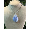 Blue Lace Agate crystal pendant necklace, featuring a delicate blue stone known for its calming and soothing properties.