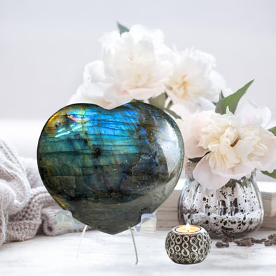 Blue Labradorite heart-shaped crystal showcasing shimmering flashes of blue and green for a stunning decorative piece.