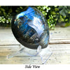 Blue Labradorite heart-shaped crystal showcasing shimmering flashes of blue and green for a stunning decorative piece.