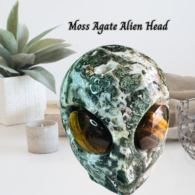 Natural Moss Agate Crystal Alien Head sculpture with intricate details and earthy green tones, perfect for decor.