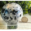 Rainbow Moonstone Crystal Sphere showcasing iridescent colors, ideal for meditation and enhancing intuition.