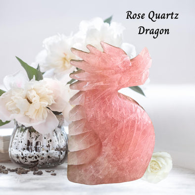 Intricate Rose Quartz Crystal Dragon Carving symbolizing love, strength, and healing with soft pink hues and fine details.